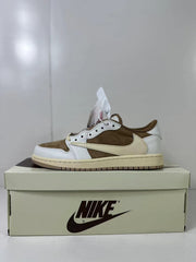 Side profile of the low-top sneaker resting on a shoebox, with a brown upper panel, white overlays, cream Swoosh, and brown outsole.