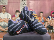 Pair of dark blue Nike basketball sneakers displayed at an angle, showing the contrasting Swoosh and textured outsole.