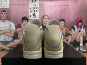 Rear view of the khaki sneaker pair showing padded heel panels, tonal stitching, and layered heel midsoles.