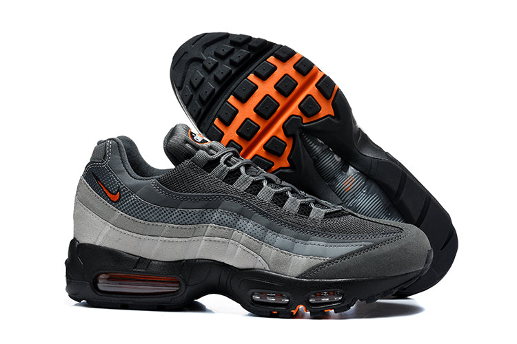 Nike Air Max 95 TT grey and orange sneakers shown from the side with the black and orange outsole visible