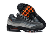 Nike Air Max 95 TT grey and orange sneakers shown from the side with the black and orange outsole visible