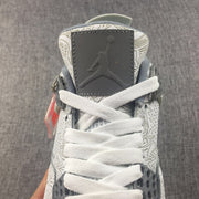 Close-up of the Jordan Air Jordan 4 tongue, white laces, gray tongue panel, and graphic-patterned upper.