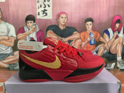 Side view of a red basketball sneaker showing a gold Swoosh, textured red upper, and black midsole section.