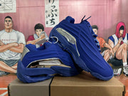 Pair of blue sneakers displayed at an angle, showing the sculpted sides and silver-tone accents.