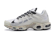 Side profile of a white sneaker with translucent panels and a speckled midsole