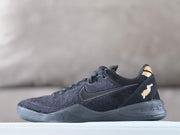 Side view of a black Nike Kobe 8 shoe with gold-tone heel detail
