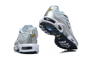 Rear and outsole views of Nike Air Max Plus sneakers, showing silver heel panels and dark tread.
