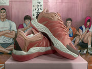 Angled view of the magenta sneaker pair highlighting the laces, side panels, heel accents, and textured sole.