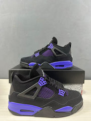 Angled side view showing the black upper, purple-blue midsole accents, mesh panels, and molded eyelets.