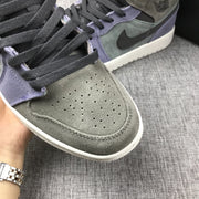 Close-up of the perforated gray toe box, black laces, and purple eyestay panel.