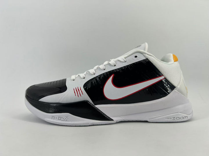 Side view of a black, white, and red Nike low-top sneaker with white laces and a contrasting Swoosh.