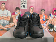 Front view of black and blue Jordan sneakers with black laces and tongue branding