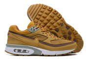 Side view of ochre Nike Air Max BW sneakers with brown trim, mesh panels, a visible Air unit, and patterned outsole.