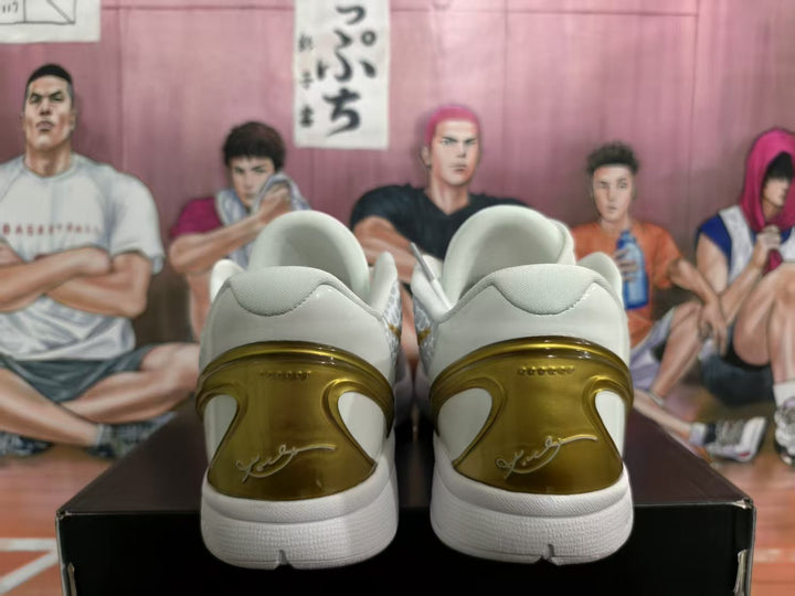 Rear view of white Nike basketball sneakers with translucent gold heel panels and padded collars.