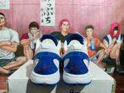Rear view of a pair of white and blue basketball shoes with blue heel details.