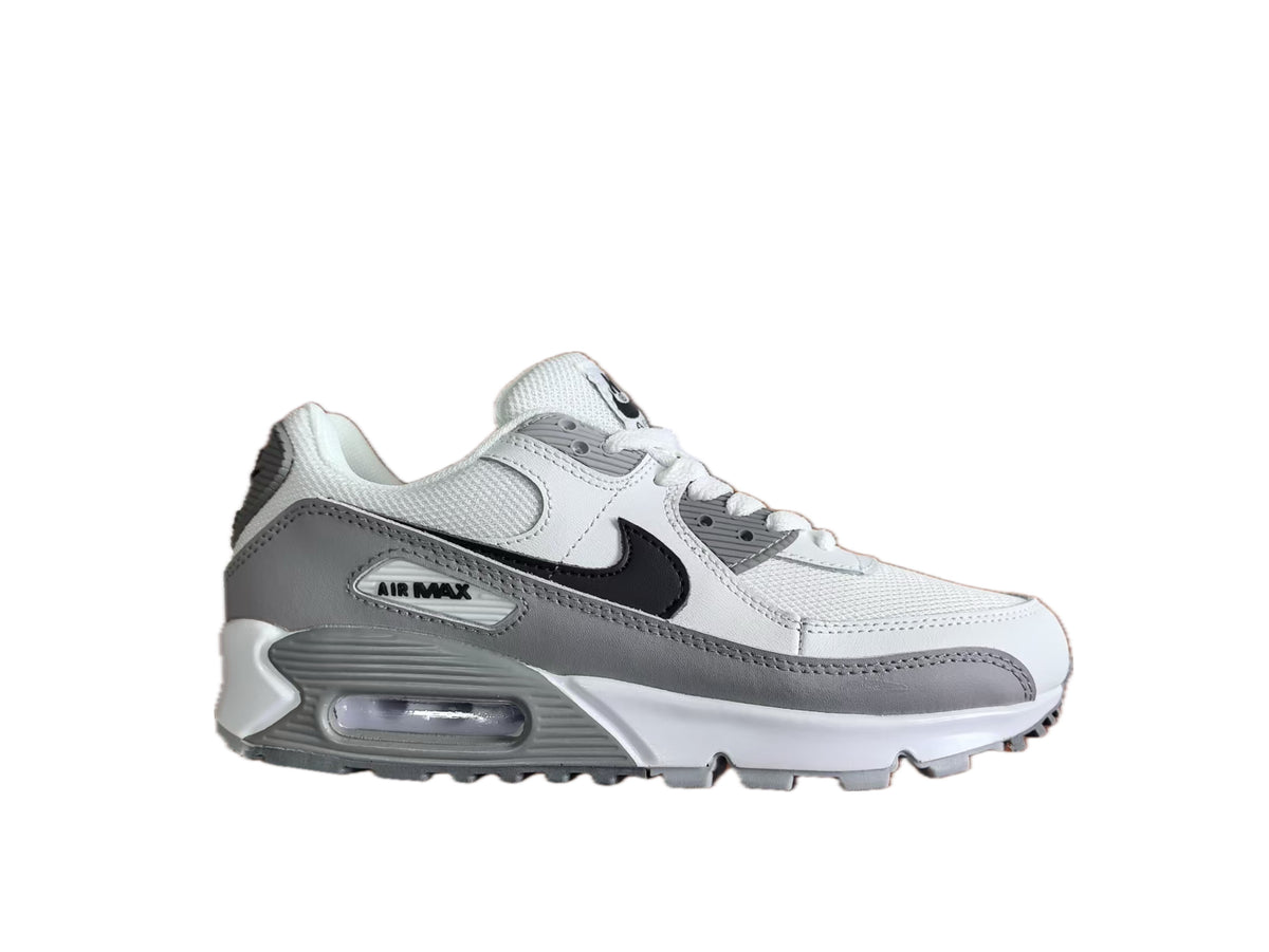 Side view of white and grey Nike Air Max sneakers with a black Swoosh and visible heel air unit