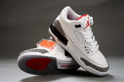 White and black Jordan sneakers arranged to show the outsole, side profile, red tongue accents, and elephant-print overlays.