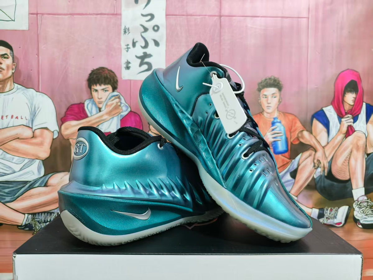 Pair of metallic aqua-teal Nike basketball shoes with black laces and pale translucent outsoles