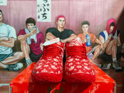 Front view of the red patterned sneakers showing red laces and white graphic details.