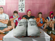 Front view of grey Nike sneakers with perforated toes and lace-up fronts.