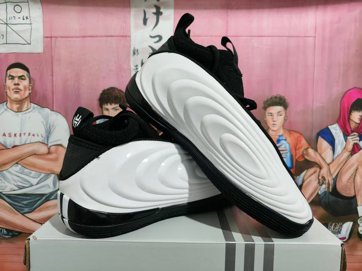 Black and white Adidas Harden Vol. 8 basketball shoes shown from the side and underside.