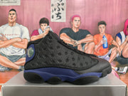 Side profile of a black and purple Jordan basketball sneaker showing the textured upper, purple midsole accents, and black outsole.