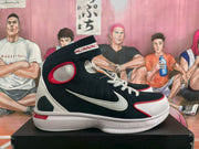 Side profile of a navy, white, and red high-top sneaker with a large white Swoosh and contrast outsole details.
