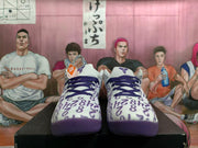 Front view of white and purple Kobe basketball shoes with patterned uppers and purple laces.