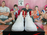 Front view of a pair of white Nike high-top basketball shoes with red collar lining and perforated toe areas.