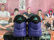 Rear view of the black and blue adidas sneakers showing green heel logos and Lightstrike branding.