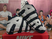 Angled view of the Nike high-top sneakers highlighting the side lettering and color-blocked design.