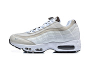 Side view of a white and light gray Nike Air Max 95 TT sneaker showing its layered panels and visible sole air units.