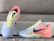 Top and side view highlighting the textured toe box, pale yellow laces and pink-and-blue color blocking.