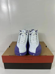 Front view of a pair of white and purple Air Jordan 12 Retro sneakers