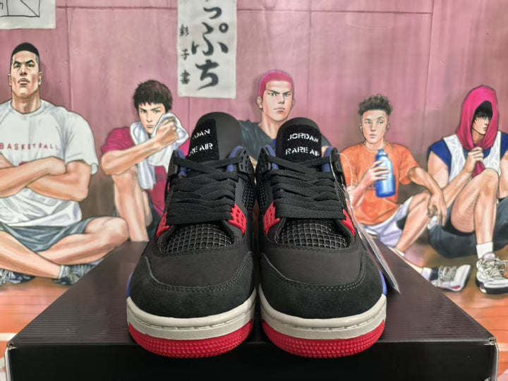 Front view of black Jordan sneakers with red and blue accents, black laces, and light-colored midsoles.