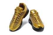 Front view of the pair of gold-tone Nike Air Max 95 TT sneakers with mesh panels and lace-up closure.
