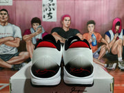 Rear view of the sneaker pair showing white textured heel sections, black heel overlays, and red accents.