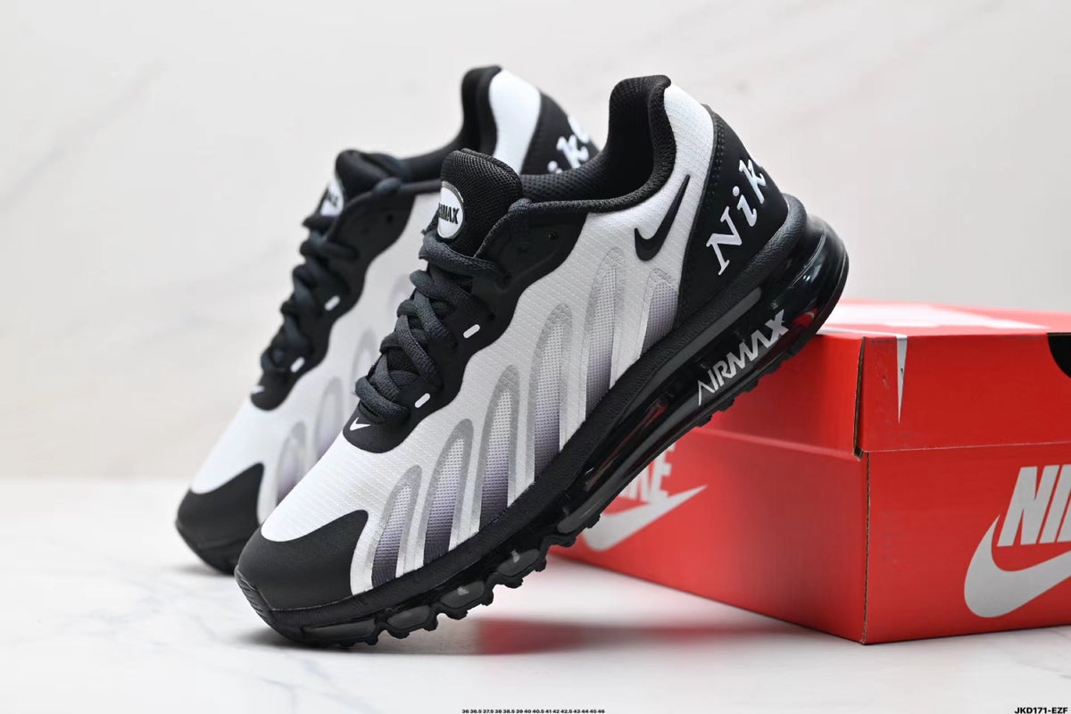 Black and white Nike Air Max sneakers displayed beside a red Nike-branded box