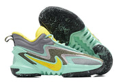 Mint green Nike Anthony Edwards 2 basketball shoes with yellow accents and dark outsole.