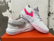 Pair of white Nike basketball shoes showing pink side accents, lavender laces, and speckled midsoles