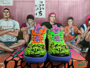 Front view showing the bold illustrated toe boxes, contrasting laces, tongue graphics, and purple outsoles.