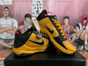 Angled view of the pair highlighting the side swoosh, yellow panels, black overlays, and red collar accents.