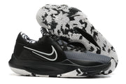 Black and gray basketball shoe with a black-and-white patterned outsole.