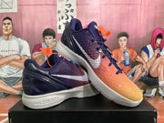 Angled view of the paired basketball sneakers highlighting the textured upper, white side branding, orange accents, and white soles.