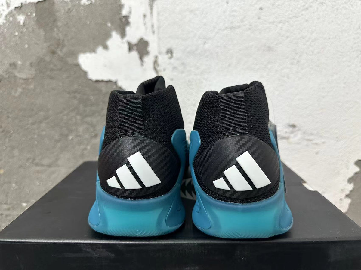 Rear view of black and blue adidas high-top basketball shoes
