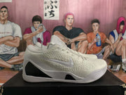 Side profile of a white Nike basketball sneaker with a textured upper, Swoosh, and sculpted white outsole.