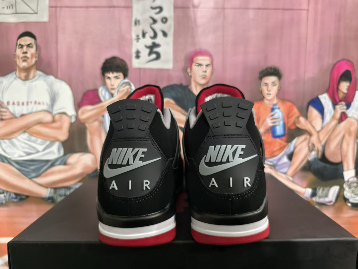 Rear view of black sneakers showing Nike Air heel branding, grey accents, and red outsole details.