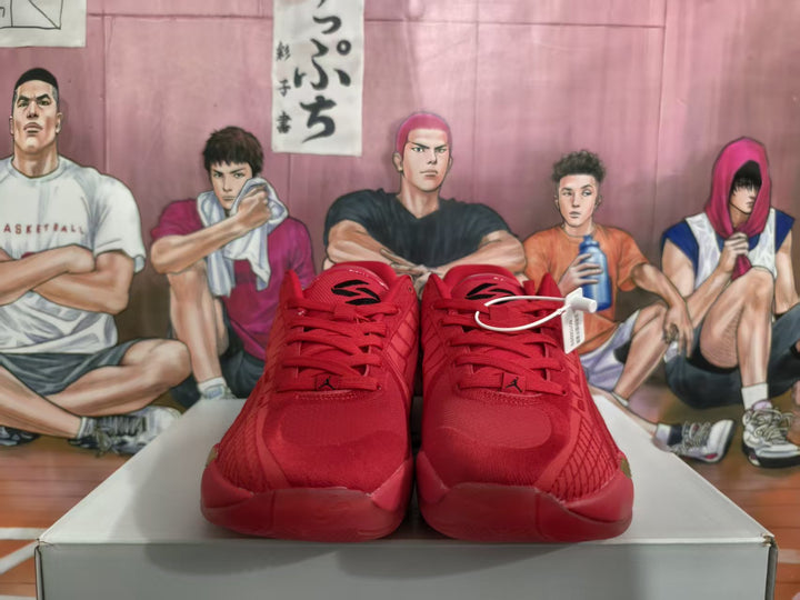 Front view of red Jordan basketball sneakers with matching laces, displayed on a box.