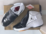 Top-down product view showing the black toe sections, woven-look panels, white collars, and box beneath.