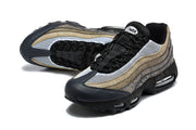 Angled top view of the Nike Air Max 95 TT pair showing mesh, laces and patterned panels.